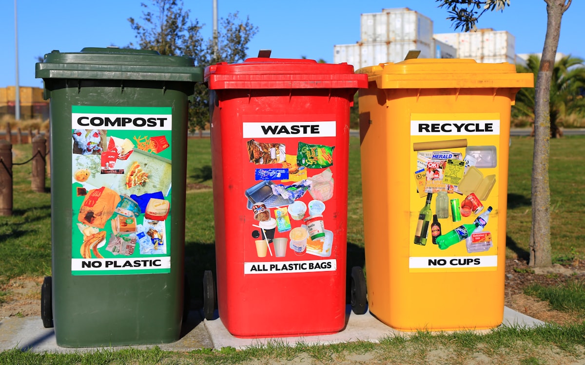 Labeled compost, waste, and recycling bins